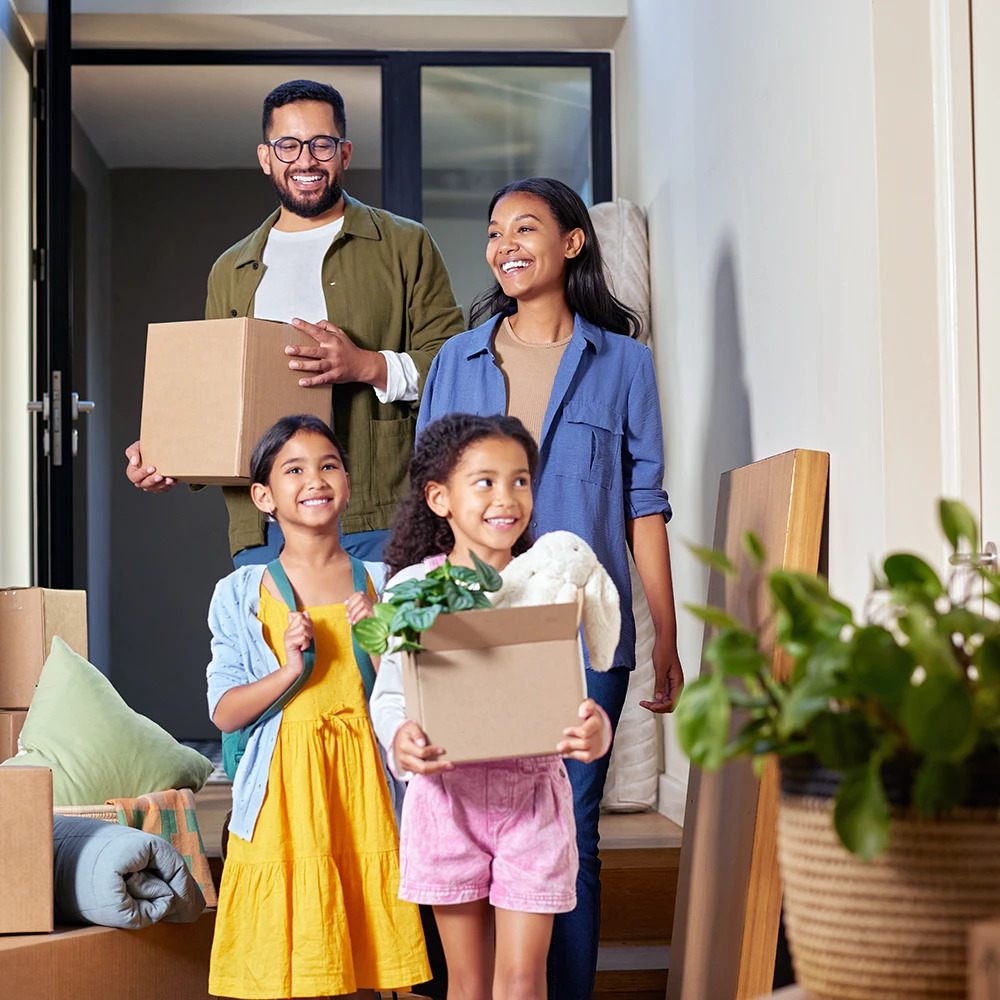 family holding moving boxes